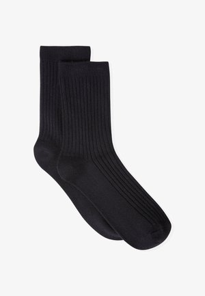 Calcetines negros de canalé hechos de una tela suave, con un patrón uniforme y una textura lisa. Diseñados para ofrecer comodidad y durabilidad.