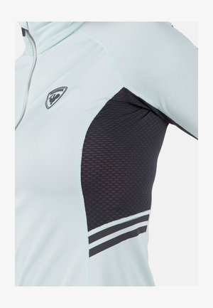 Light blue athletic jacket with a black mesh panel, silver zipper, logo on the chest, and striped accents on the sleeve. Textured fabric.