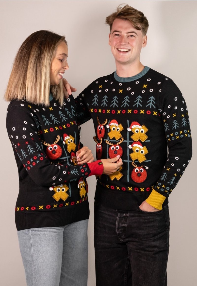 Black knit sweaters with festive designs, featuring multicolored reindeer and Christmas motifs, with red and yellow cuffs.