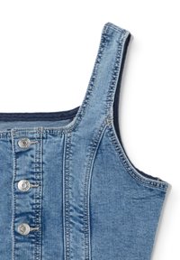 Denim vest with a light blue hue, featuring a button closure, visible stitching, and wide straps. The fabric has a smooth texture.