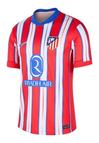 Tricou de fotbal cu dungi roșii și albe, cu accente albastre, având logo-ul Nike și un emblema a clubului. Material neted cu un design în formă de V.