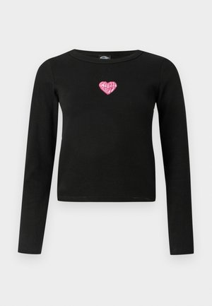 Musta pitkähihainen paita, jossa on kiinteä muotoilu. Siinä on pinkki sydämen brodeeraus, jossa on "Santa Cruz" -teksti keskellä etuosaa.