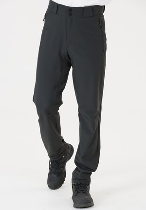 Schwarze Outdoor-Hosen im Slim-Fit, aus robustem Material. Mit seitlichen Reißverschlusstaschen und einem flachen Bund mit zwei Knöpfen.