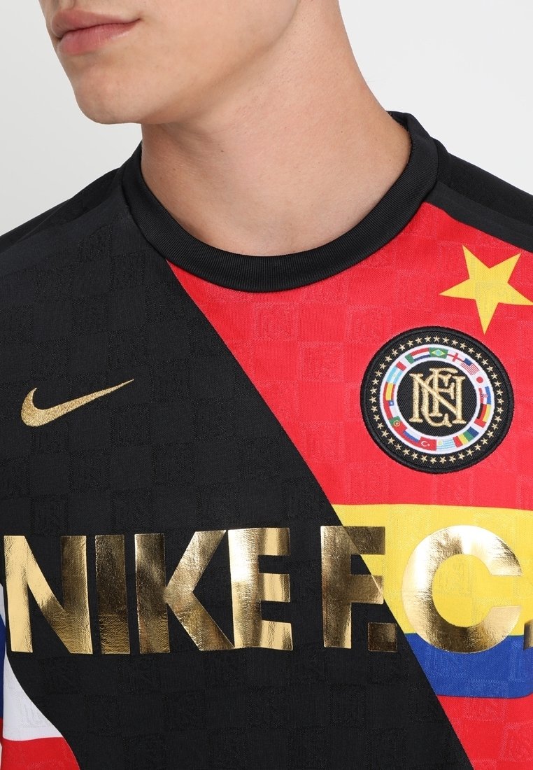 red black and gold nike shirt
