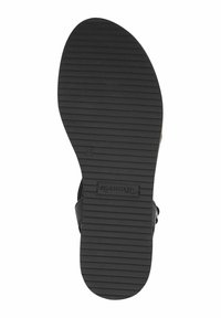 Svart gummisula för sandaler med ett strukturerat, ribbat mönster. Inkluderar en Tom's-logotyp och en distinkt böjd form vid hälen för bättre grepp.