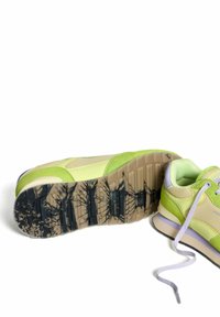 Sneakers with a beige and vibrant green design, synthetic upper, textured sole, and contrasting black and purple accents. Rubber outsole.