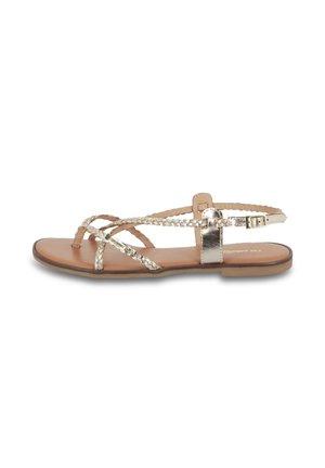 Sandales plates avec des brides entrelacées en métal argenté, semelle en cuir marron, boucle ajustable à la cheville et design minimaliste.