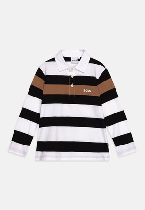 Koszula polo z długim rękawem w białe, czarne i brązowe poziome paski. Posiada kołnierzyk, trzy guziki oraz małe logo na klatce piersiowej.