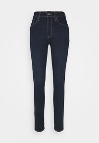 Jeans skinny de denim azul oscuro con cintura alta, cinco bolsillos y costuras en contraste. Textura suave con un ligero estiramiento.
