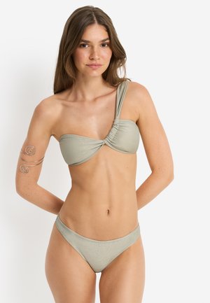 Light green shimmer bikini top with one shoulder strap and gathered detail, paired with matching low-rise bikini bottoms. Smooth texture.