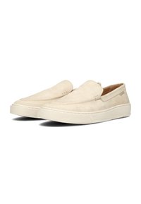 Scarpe slip-on in camoscio beige con punta tonda, cuciture minime e suola in gomma bianca tessurizzata. Design semplice senza hardware visibile.