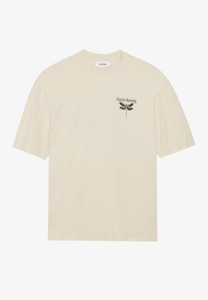 Short-sleeve beige t-shirt, cotton material, features black "Floral & Blooming" text and dragonfly graphic on chest. Simple design, crew neck.