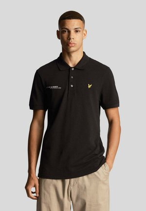 Polo shirt nero in cotone, con colletto a due bottoni, maniche corte e un piccolo logo di un'aquila gialla sul petto.