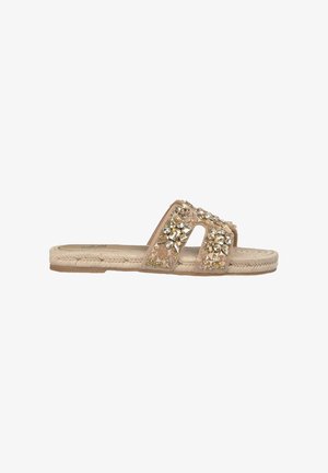 Sanda les beiges avec deux larges lanières, ornées de strass clairs et de strass dorés, et une semelle en corde naturelle.