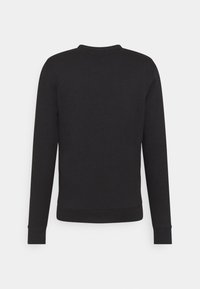 Sweat-shirt noir à manches longues avec col rond, poignets et ourlet côtelés, présenté de dos sur un fond clair uni.