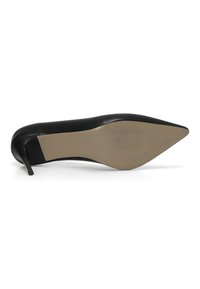 Black pointed-toe high heel shoe with a sleek leather upper and a beige rubber sole, featuring a thin stiletto heel and subtle texture patterns.