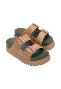 Sandali in gomma tan con doppie cinghie regolabili, soletta verde, suola spessa e motivo testurizzato sulle cinghie. Dettaglio logo in rilievo visibile.