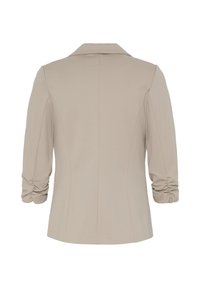 Blazer beige pour femme avec manches trois-quarts froncées et col à revers visible de dos sur fond blanc.