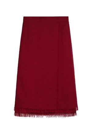 Red skirt with a straight cut, featuring a fringed hem and textured fabric. Simple waistband, no visible hardware or embellishments.