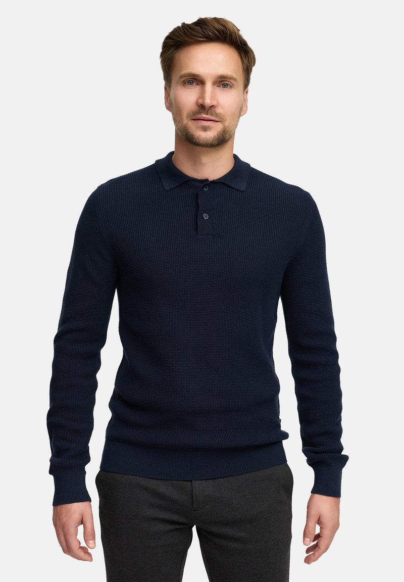 Navyblaues gestricktes Poloshirt mit langen Ärmeln, gerippter Textur und Knopfleiste. Mit eng anliegenden Bündchen und geradem Saum.