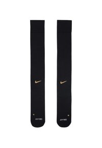 Calzini sportivi neri con bordo a coste, caratterizzati dal logo swoosh dorato di Nike. Il materiale sembra liscio ed elastico, progettato per il comfort.