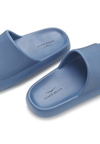 Blue slip-on sandals made of textured rubber. Features a perforated insole and raised edges. Branding visible on the footbed.