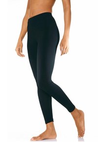 Leggings noirs avec une taille haute, en matériau lisse et extensible. Design ajusté, longueur cheville, sans motifs visibles ni quincaillerie.