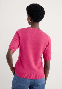 Short-sleeved pink knit sweater with a ribbed neckline and cuffs, featuring a smooth texture and a relaxed fit.