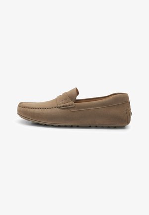 Brown suede loafers with stitched detailing, soft texture, flat rubber sole, and a small logo near the heel, designed for comfort.