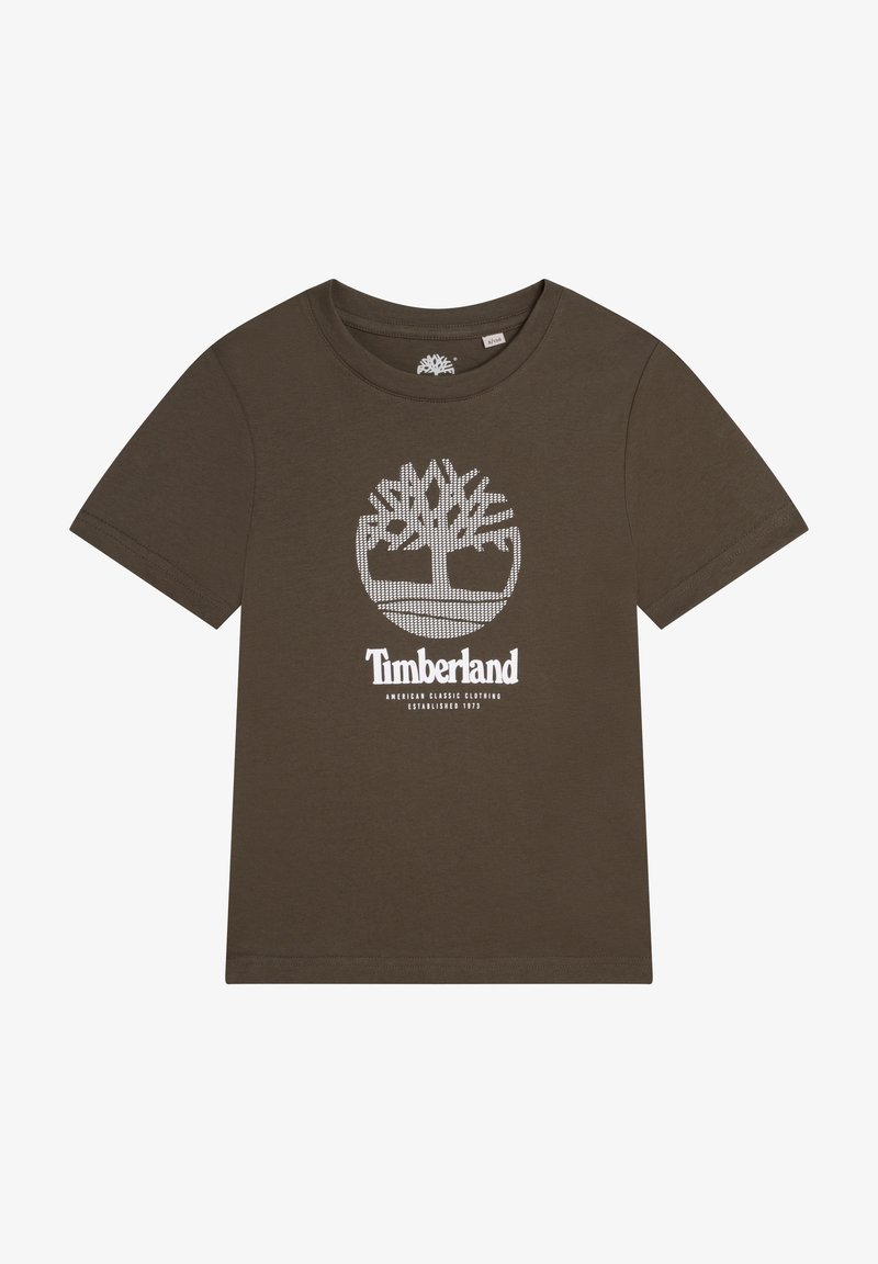 Ruskea lyhythihainen T-paita, joka on valmistettu puuvillasta. Edessä on valkoinen graafinen puulogo ja brändin nimi keskellä.