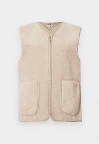 Vest din fleece bej cu închidere cu fermoar și decolteu în V. Caracteristici două buzunare frontale cu margini curbate. Textură moale și design minimalist.