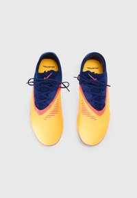 Yellow and navy athletic shoes with a textured upper, lace closure, and orange accents. The sole is curved for performance.