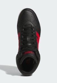 Czarne buty sportowe z czerwonymi akcentami, z górą z gładkiej skóry, perforowanym toe dla wentylacji i czarnymi sznurowadłami.