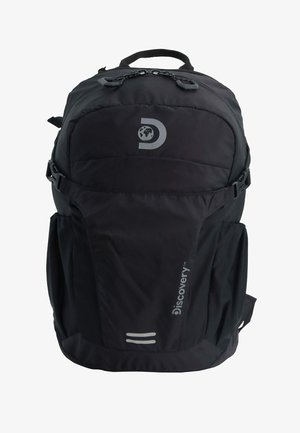 Black backpack with padded exterior, adjustable straps, reflective accents, side pockets, and a prominent logo on the front.