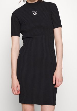 Black ribbed dress with a high neckline and short sleeves featuring a silver "HUGO" logo on the chest. Slim fit design.