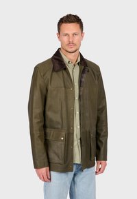 Olive green leather jacket with a brown suede collar, front pockets, and plaid lining. Features a classic design with snap buttons.