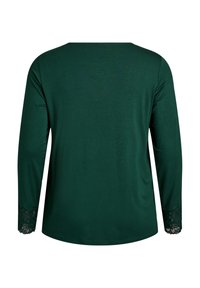 Temno zelen vrh z dolgimi rokavi iz gladkega blaga, z izjemnimi čipkastimi poudarki na manšetah in preprostim okroglim izrezom.