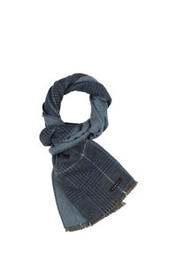 Écharpe bleue avec un design patchwork, présentant différentes textures et motifs. Des bords frangés et une petite étiquette logo noire sont visibles.