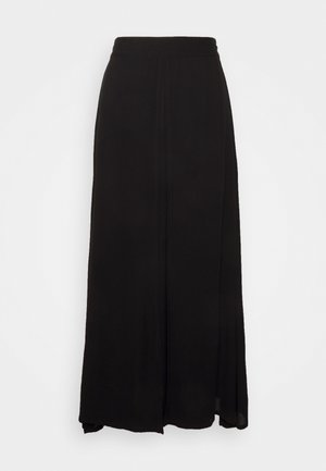 Black maxi skirt made of lightweight fabric, featuring a flowy design with a smooth texture and side slits for movement.