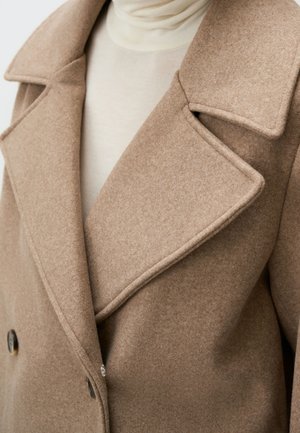 Double-breasted wool coat in light brown. Features wide lapels, textured fabric, and two round buttons near the hem.