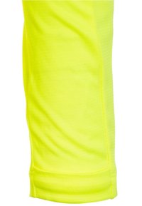 Helle gelbe Sportleggings aus weichem, elastischem Stoff mit glatter Textur. Verfügt über einen gesäumten Saum am Knöchel und seitliche Nähte.