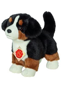 Plush dog toy featuring black, brown, and white fur, realistic facial details, and a hanging tag. Stands upright with a soft texture.