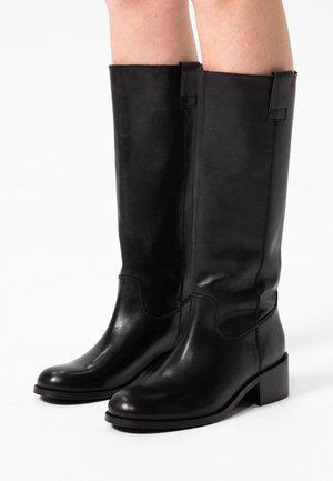 Black leather knee-high boots with a rounded toe, low block heels, and subtle stitching accents. Smooth texture with no visible patterns.