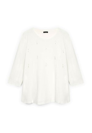 Hvid langærmet bluse med rund halsudskæring og kviltet diamantmønster forskyndet med små hængende perler over brystet.