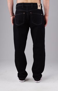 Black denim jeans with a straight fit, featuring copper rivets, contrast stitching, and a branded leather patch at the waistband.