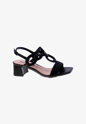 Sandal nera con design a strappo intrecciato, punta aperta e un tacco a blocco modesto. Realizzata in materiale sintetico con una finitura liscia.