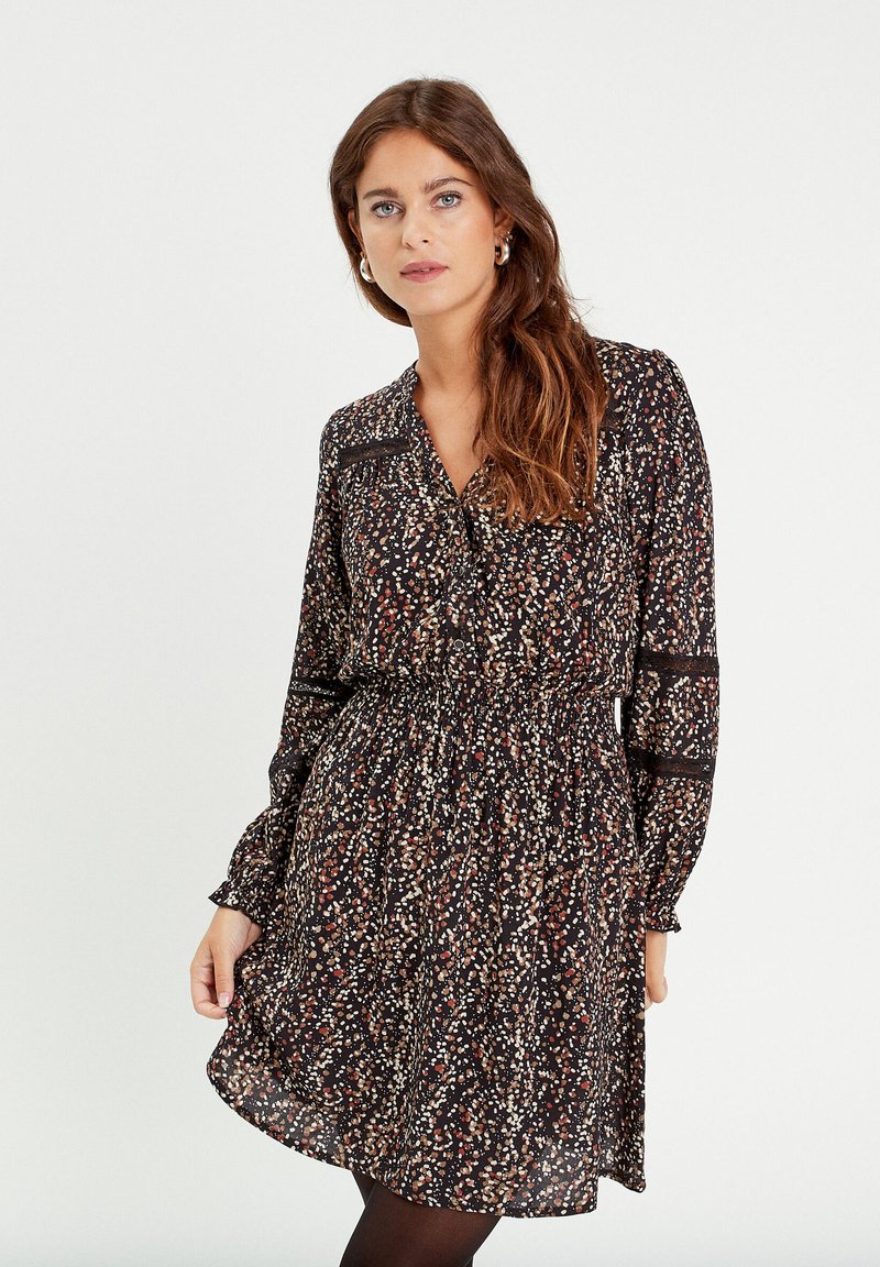 Black floral dress with long sleeves, v-neck, and gathered waist. Features multicolored scattered patterns and sheer lace accents.