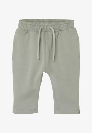 Shorts in cotone verde chiaro con vita elastica e coulisse, dotati di due tasche laterali e una superficie liscia.