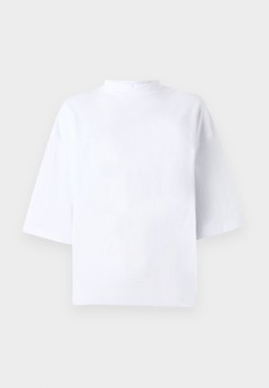 White cotton short-sleeve top with a high, rounded neckline and loose fit. Smooth texture, no visible patterns or accents.