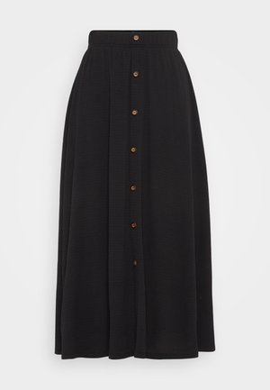 Sort lang nederdel med elastisk talje, der har lukning foran med knapper og tekstureret stof. Knapperne er brune og jævnt fordelt.